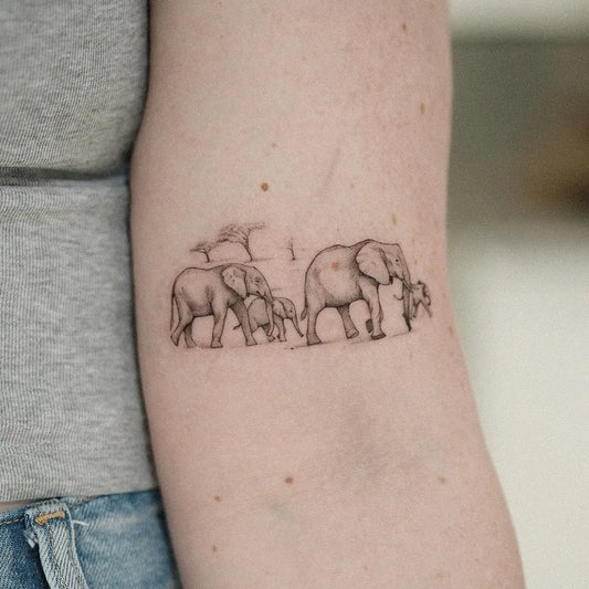 Small Black and Grey Elephant Family Tattoo on Women Arm by @zoe.tattoos