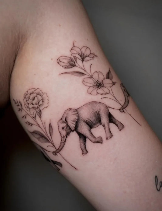 Small Black and Grey Elephant and Flowers Tattoo on Women Arm by @laurea.ink