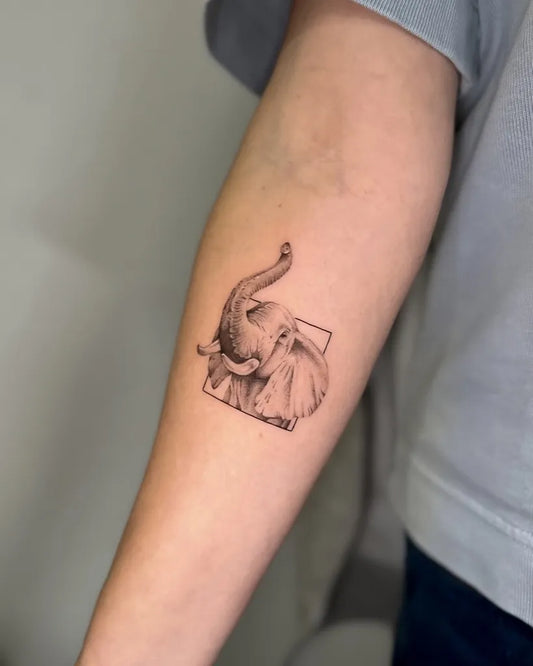 Small Black and Grey Elephant in Frame Tattoo on Women Arm by @flowtatts