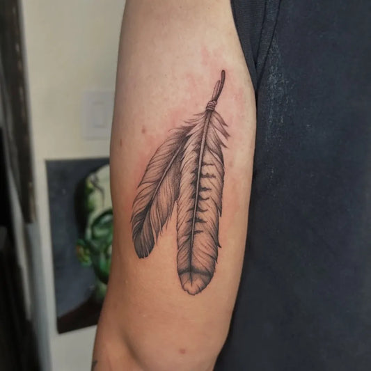 Small Black and Grey Feather Tattoo on Men Arm by @sierahskyetattoos