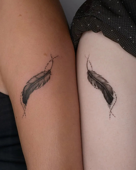 Small Black and Grey Feather Tattoo on Women Arm by @libertyjtattoo
