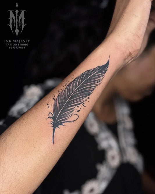 Small Black and Grey Feather Tattoo on Women Wrist by @inkmajestytattoo