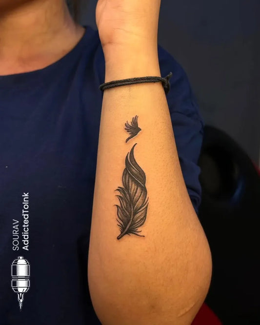 Small Black and Grey Feather and Bird Tattoo on Women Forearm by @addic.tedtoink