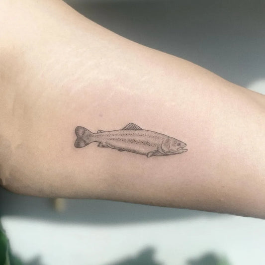 Small Black and Grey Fish Tattoo on Women Arm by @mudi.ink