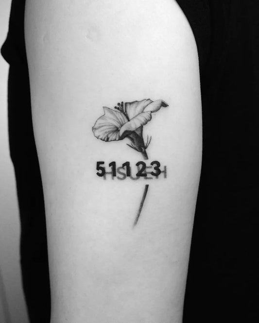 Small Black and Grey Flower Number Tattoo on Women Upper Arm by @guccida