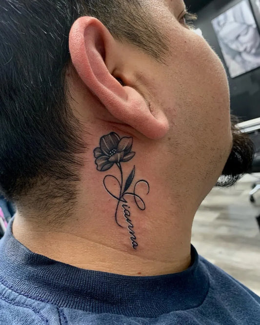 Small Black and Grey Flower and Script Tattoo on Men Behind the Ear by @vivica_ink