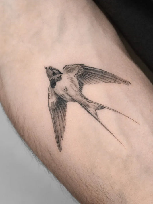Small Black and Grey Flying Swallow Tattoo on Men Arm by @lemontreeink