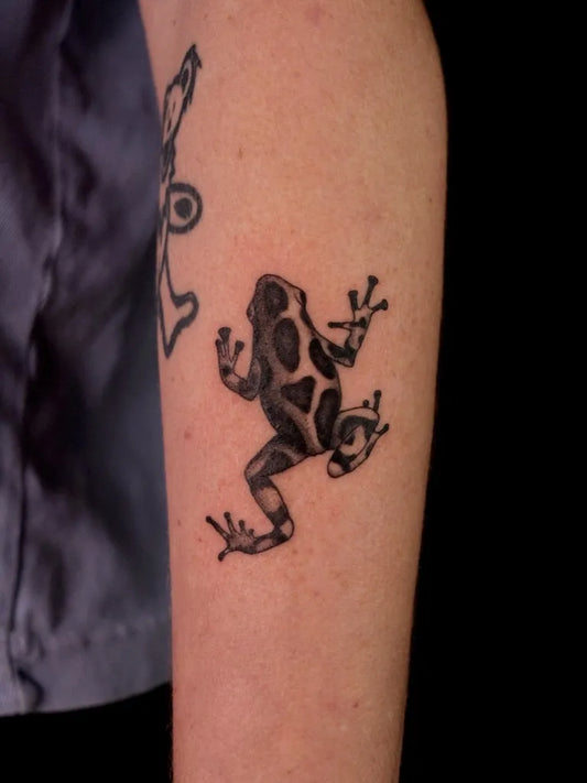 Small Black and Grey Frog Tattoo on Women Arm by @shaypokes