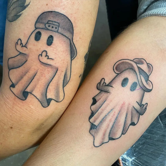 Small Black and Grey Ghost with Cap Halloween Tattoo on Women Arm by @sincerelyctattoos