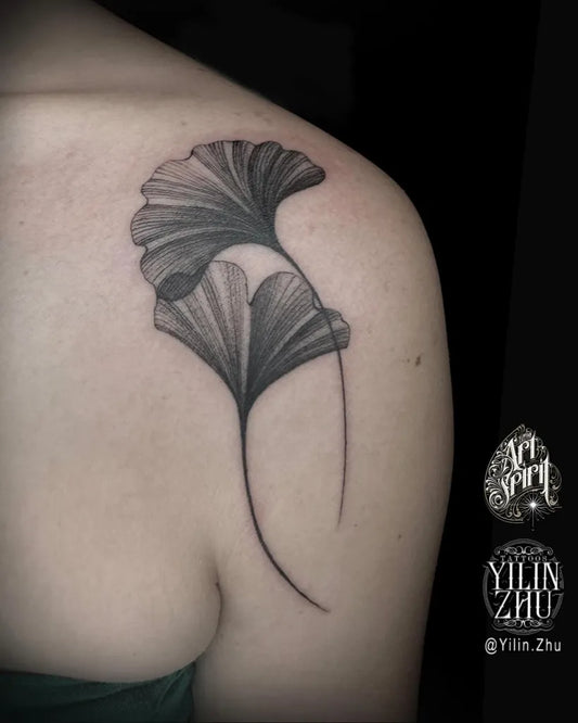 Small Black and Grey Ginkgo Leaves Tattoo on Women Shoulder by @yilin.zhu