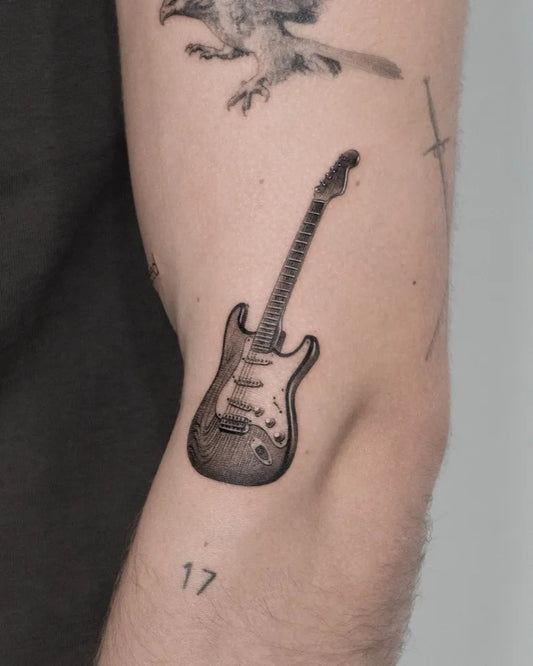 Small Black and Grey Guitar Tattoo on Men Arm by @lemontreeink