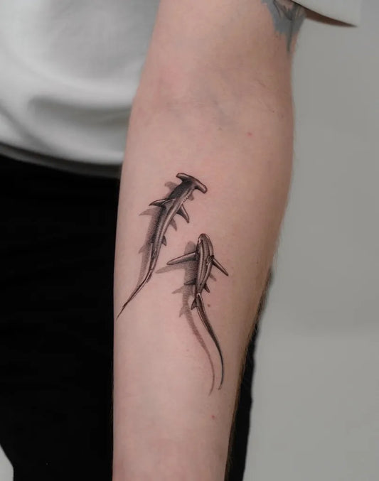 Small Black and Grey Hammerhead Sharks on Women Arm Tattoo by @eklor.ttt