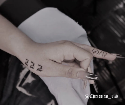Small Black and Grey Hebrew Script Number Tattoo on Women Finger by @christian_1nk