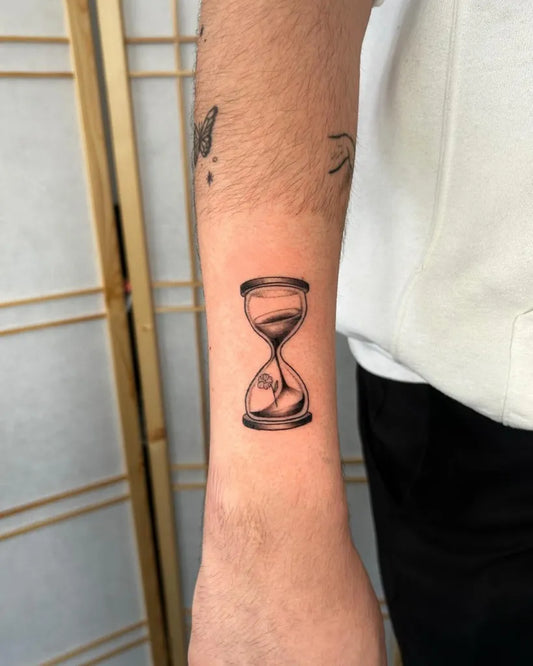 Small Black and Grey Hourglass Tattoo on Men Arm by @julia.tatts