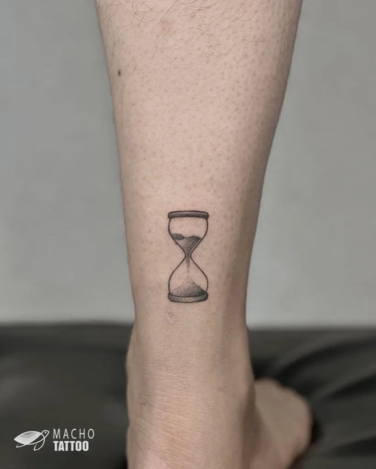 Small Black and Grey Hourglass Tattoo on Women Ankle by @machotattoo