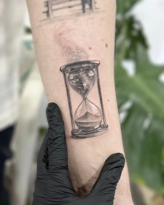 Small Black and Grey Hourglass Tattoo on Women Arm by @dari.inks