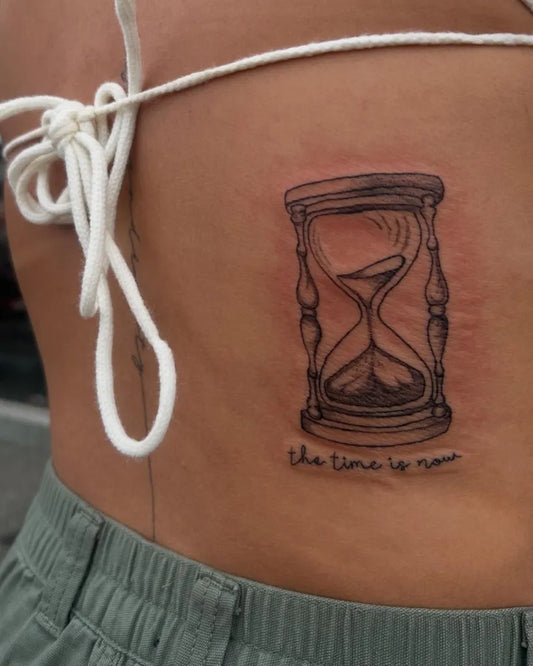 Small Black and Grey Hourglass and Quote Tattoo on Women Side by @mads2thabone