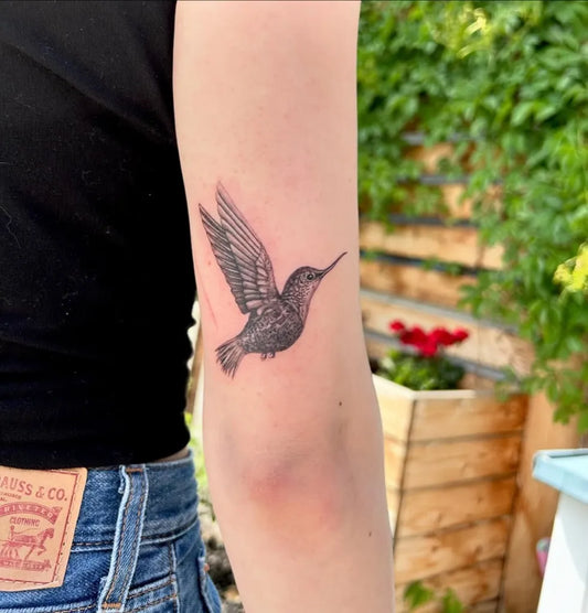 Small Black and Grey Hummingbird on Women Arm Tattoo by @khloztatz