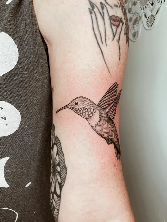 Small Black and Grey Hummingbird on Women Arm Tattoo by @overzealous.ink