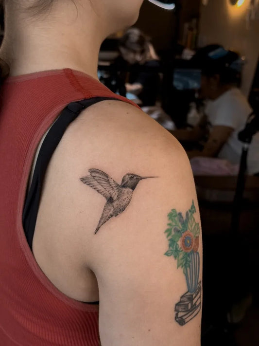 Small Black and Grey Hummingbird on Women Shoulder Tattoo by @lukas.ejsmont