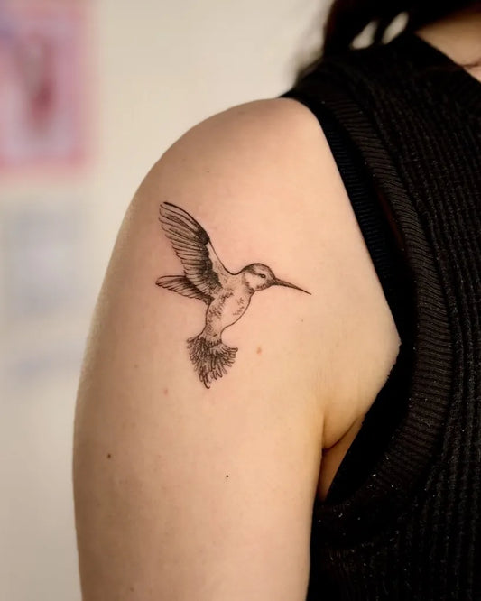 Small Black and Grey Hummingbird on Women Shoulder Tattoo by @pixeldust.tattoo