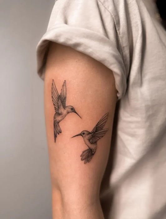 Small Black and Grey Hummingbirds Tattoo on Women Arm by @shenoalundgren