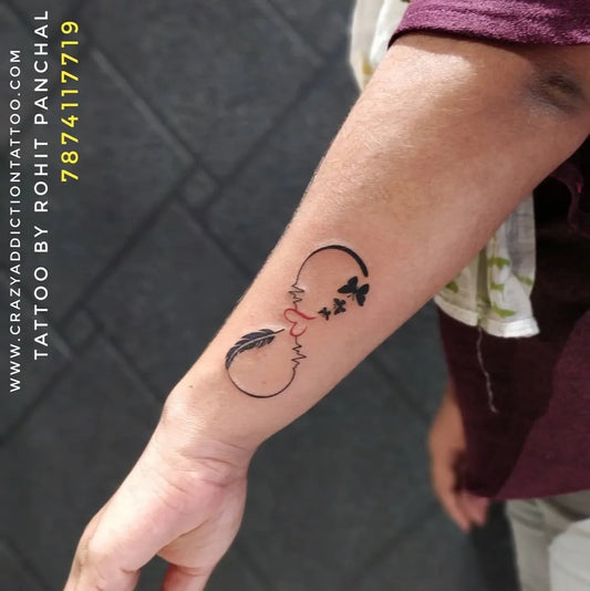 Small Black and Grey Infinity Heart Feather Tattoo on Men Forearm by @crazy_addiction_tattoos