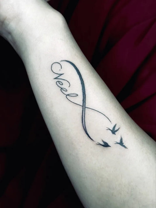 Small Black and Grey Infinity Name Birds Tattoo on Women Wrist by @ajtattoopune