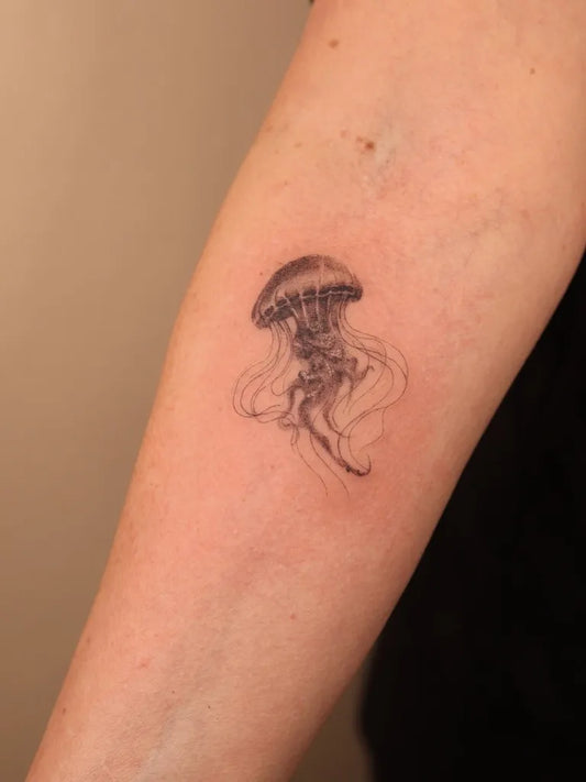 Small Black and Grey Jellyfish Tattoo on Women Arm by @alialenaa_inkk