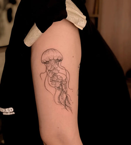 Small Black and Grey Jellyfish Tattoo on Women Arm by @credencetattoo