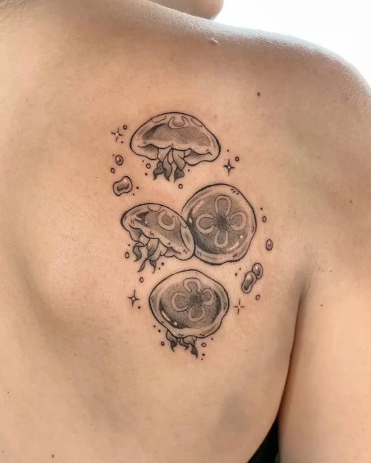 Small Black and Grey Jellyfish Tattoo on Women Shoulder by @st.inkyjuliet