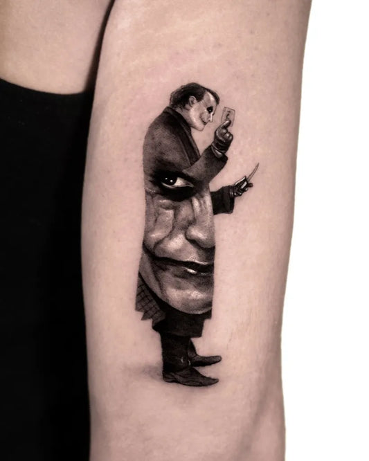 Small Black and Grey Joker Portrait on Women Arm Tattoo by @kenneth.ink