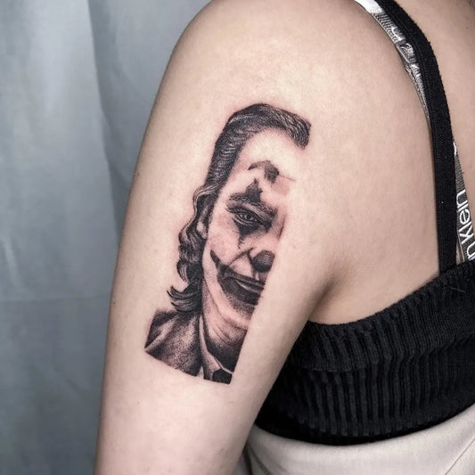 Small Black and Grey Joker Portrait on Women Shoulder Tattoo by @leeyuanyip