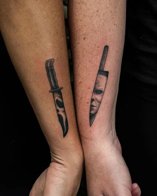Small Black and Grey Knife and Mask Horror Tattoo on Women Arm by @thesilverkeytattoo