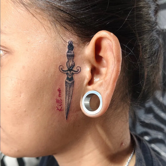 Small Black and Grey Knife with Text Tattoo on Women Neck by @waroengtattoo