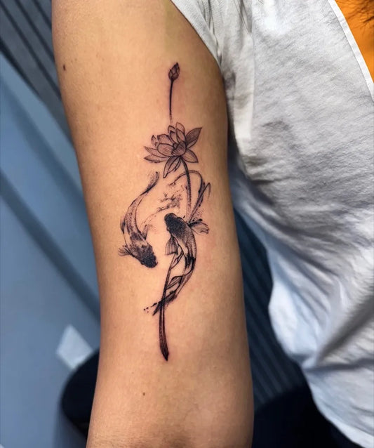 Small Black and Grey Koi and Lotus Tattoo on Women Upper Arm by @sagar_tat2