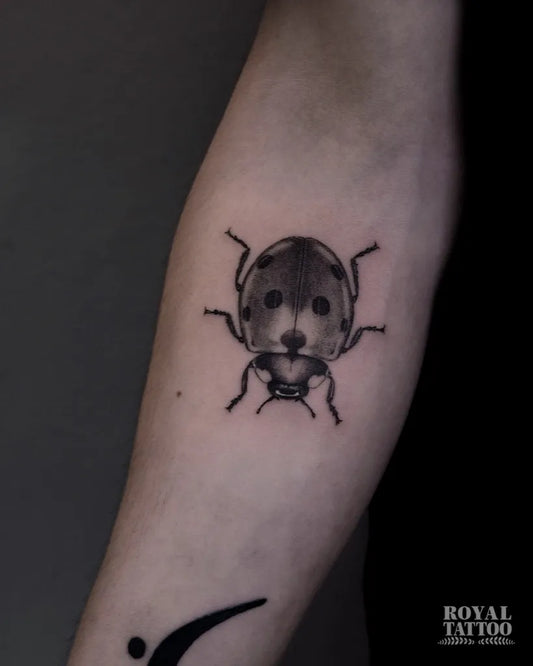 Small Black and Grey Ladybug Tattoo on Women Forearm by @royaltattooyyc