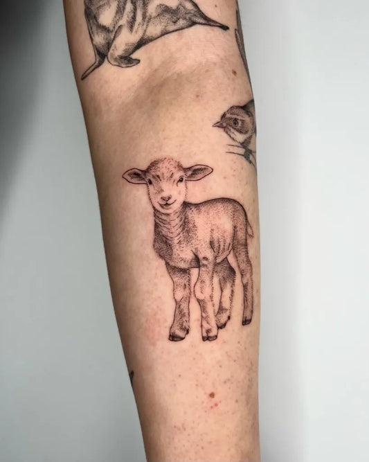 Small Black and Grey Lamb Tattoo on Women Arm by @iriswoodtattoo