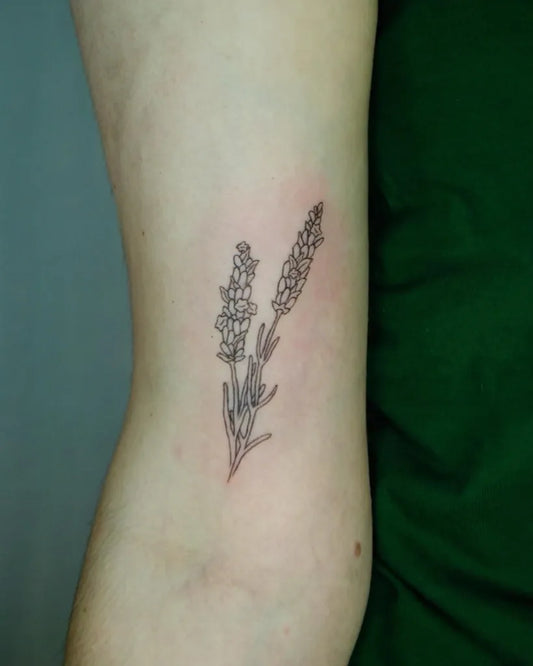 Small Black and Grey Lavender Stem Tattoo on Women Bicep by @sincerelybriget