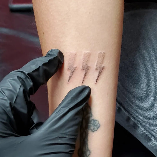 Small Black and Grey Lightning Bolt Tattoo on Women Forearm by @carrie_metz_caporusso