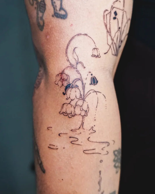 Small Black and Grey Lily of the Valley Flowers and Bee on Women Leg Tattoo by @fuu.tattoo