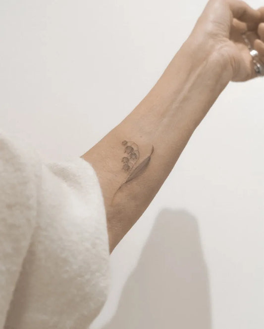 Small Black and Grey Lily of the Valley Women Wrist Tattoo by @natalie.vadelma