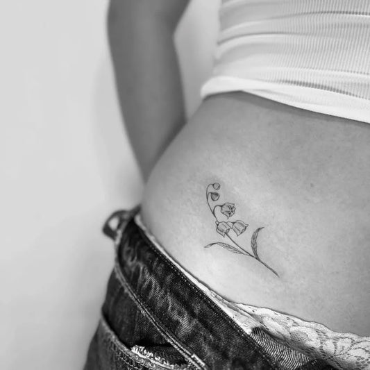 Small Black and Grey Lily of the Valley on Women Hip Tattoo by @realigntattoo