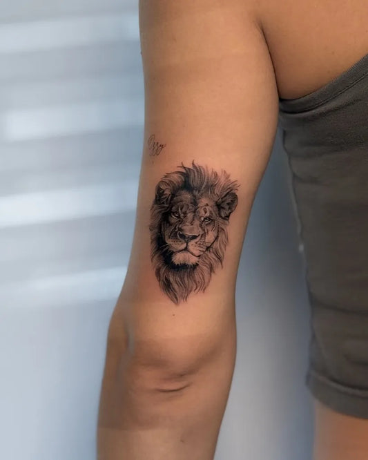 Small Black and Grey Lion on Women Arm Tattoo by @victoria.tattoos