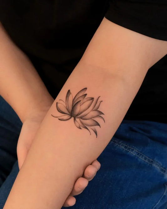 Small Black and Grey Lotus Flower on Women Arm Tattoo by @silvieetattoo