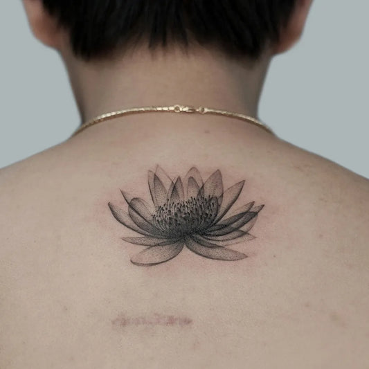 Small Black and Grey Lotus Flower on Women Back Tattoo by @cici.geeink.jpg