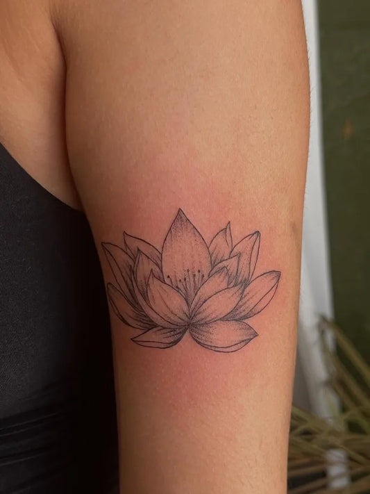 Small Black and Grey Lotus Flower on Women Upper Arm Tattoo by @vonze_tatts