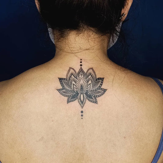 Small Black and Grey Lotus Flower with Dots on Women Back Tattoo by @eric_manio