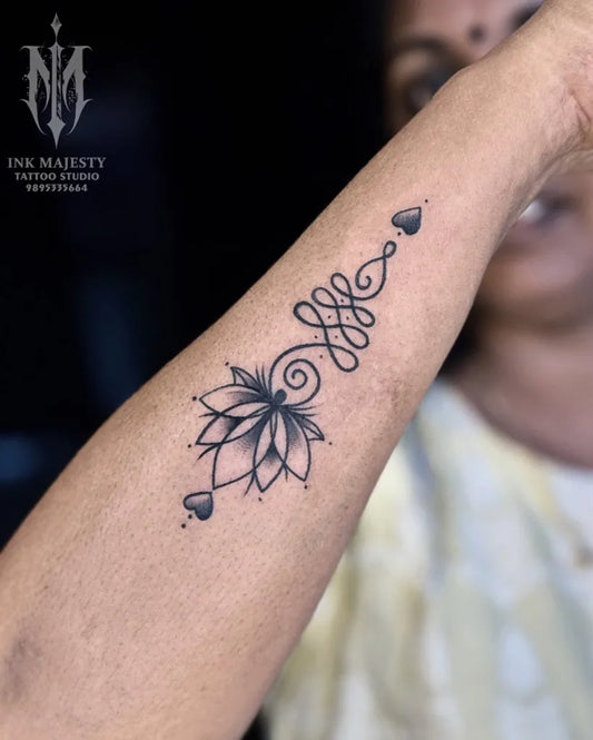 Small Black and Grey Lotus Flower with Unalome on Women Forearm Tattoo by @tattoo_ink_majesty_taliparamba
