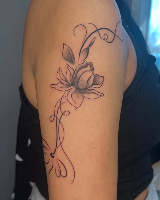 Small Black and Grey Lotus Flower with Vines on Women Shoulder Tattoo by @harmlesskittytattoo